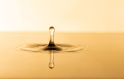 Close-up of water falling against white background