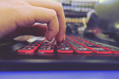 Cropped hand of person using laptop