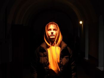 Portrait of young woman standing in tunnel