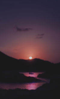 Scenic view of sea against romantic sky at sunset