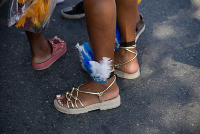 Passers-by dressed in costume are seen during the fuzue pre-carnival performance 