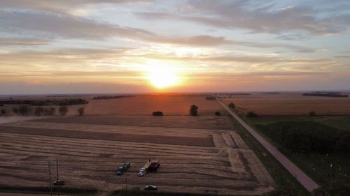 Scenic view of field against sky during sunset