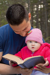 Portrait of mother and daughter on book