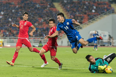 People running on soccer field