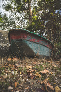 Abandoned truck on field in forest