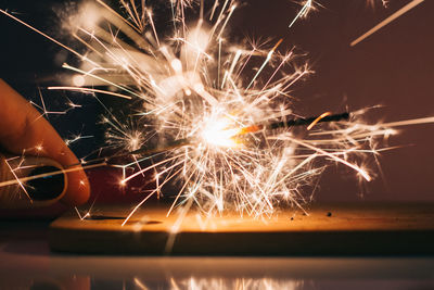 Cropped image of woman hand holding sparkler