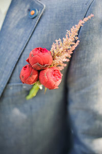 Close-up of roses in man pocket