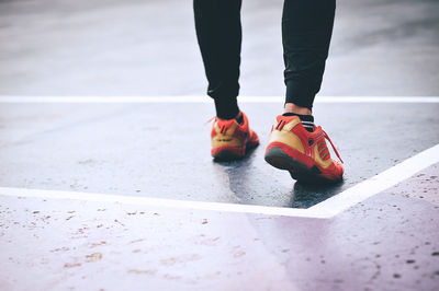 Low section of man standing on road