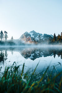 Scenic view of lake against clear sky during winter