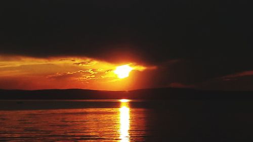 Scenic view of sea against romantic sky at sunset