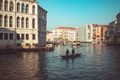 Rear view of people in boat on grand canal