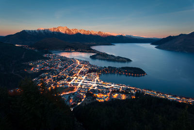 High angle view of illuminated cityscape against sky