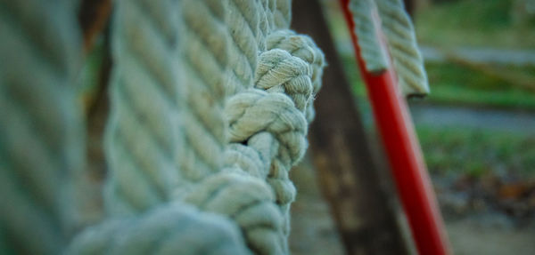 Close-up of rope tied on wooden post