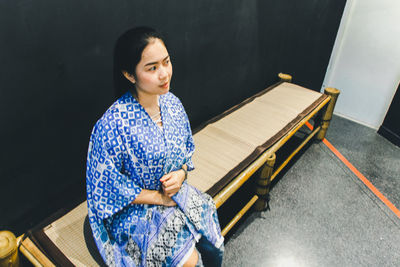 High angle view of woman sitting on floor