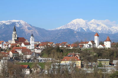 Townscape by mountains against clear sky