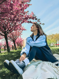 Portrait of young woman sitting on field