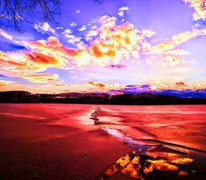 Scenic view of beach against dramatic sky