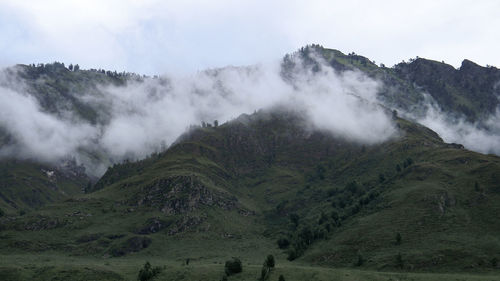 Scenic view of waterfall against sky