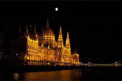 Illuminated city against sky at night