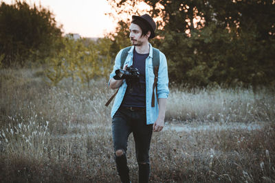 Full length of young man standing on field