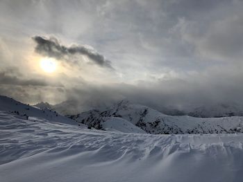 Scenic view of snow covered mountains against sky