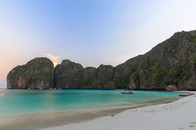 Scenic view of sea and mountains against sky