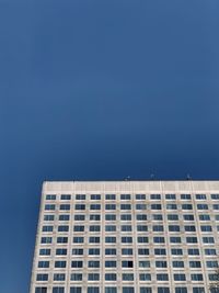 Low angle view of building against clear blue sky