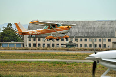 Airplane on field against sky