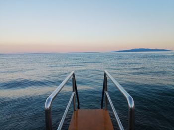 Scenic view of sea against clear sky during sunset