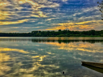 Scenic view of lake against sky at sunset