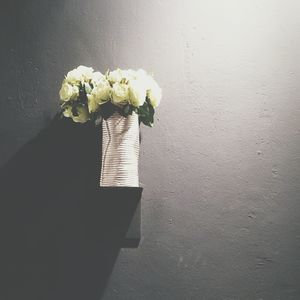 Close-up of flower vase against wall