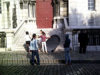 Rear view of people walking on street