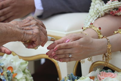 Midsection of bride holding hands