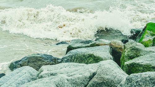 Waves rushing towards rocky shore