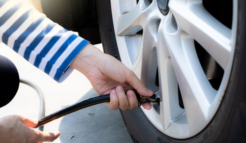 Cropped hand of man holding steering wheel