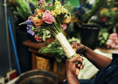 Midsection of woman holding flower