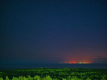 Scenic view of field against sky at night