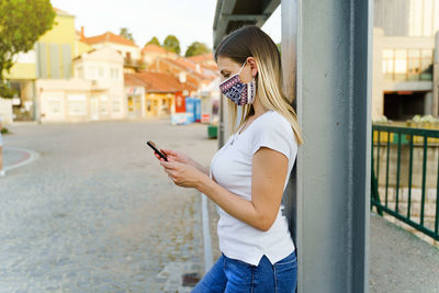 Midsection of man using mobile phone