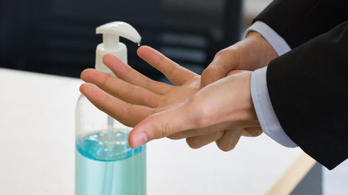 Close-up of hand holding bottle