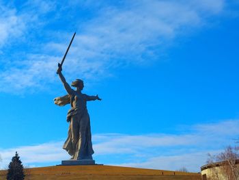 Low angle view of statue against blue sky