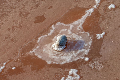 High angle view of wet sand on beach