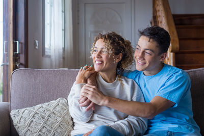 Happy woman sitting on sofa