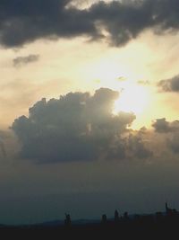 Silhouette of landscape against cloudy sky