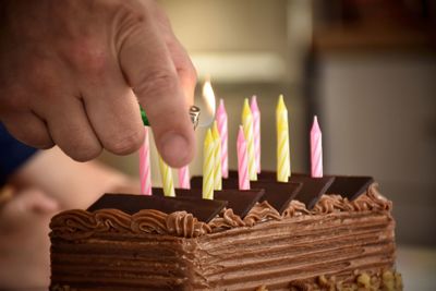 Cropped hand of person preparing cake