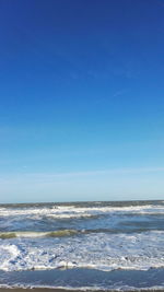 Scenic view of sea against blue sky