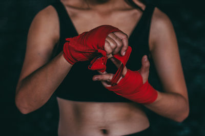 Midsection of woman holding red umbrella