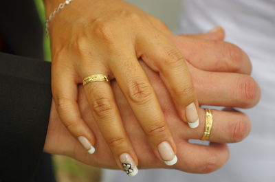 Cropped image of wedding couple holding hands