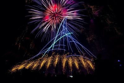 Low angle view of firework display at night