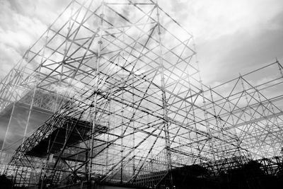 Double exposure image of construction site against sky