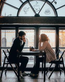 Woman sitting on chair at table